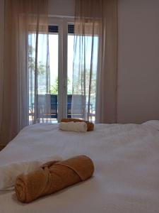 a bedroom with a large white bed with a window at Holiday Home Paradise in Prozor