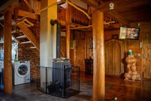 a room with a washing machine in a wooden house at Chata Ujo in Hranice