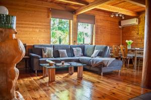 a living room with a blue couch and a table at Chata Ujo in Hranice