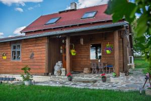 a log cabin with a table and chairs in front of it at Chata Ujo in Hranice