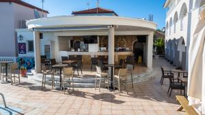 a gazebo with tables and chairs on a patio at Georgia Apartments in Tsilivi