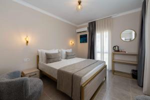 a hotel room with a bed and a chair at Porto Sol Hotel Bodrum in Bodrum City