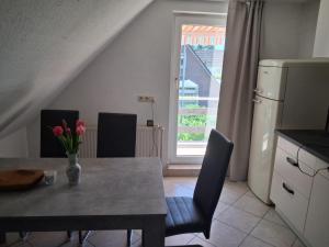 a kitchen with a table with a vase of flowers on it at Sonnennest am Stadtrand in Schwerin