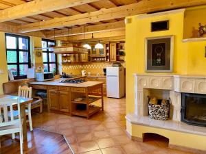 a large kitchen with a fireplace in the middle at Chalupa Beliankovo Ždiar in Ždiar