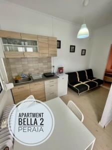 a kitchen and a living room with a table at Apartment Bella 2 Perea in Perea