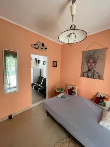 a bedroom with a large bed and a living room at Apartment Bella 2 Perea in Perea