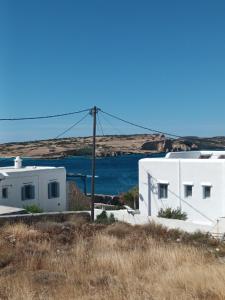 a group of white buildings on a hill with a body of water at Evdokia3 in Koufonisia