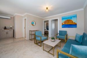 a living room with a couch and chairs and a table at Porto Sol Hotel Bodrum in Bodrum City