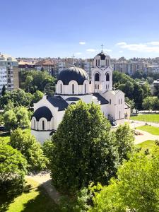 a large white building with two domes on top of it at Refresh apartman in Belgrade
