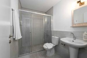 a bathroom with a shower and a toilet and a sink at Porto Sol Hotel Bodrum in Bodrum City