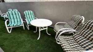 a group of chairs and a white table and chairs at The Canvas Hotel in Abbottabad