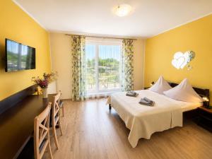 a hotel room with a bed and a window at Neptun in Kołobrzeg