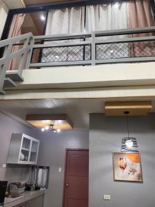 a staircase in a room with a kitchen at ZK Loft Staycation Gensan in General Santos
