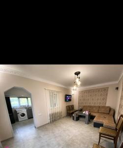 a living room with a couch and a table at Galaluxe in Tʼeghut +18 photos