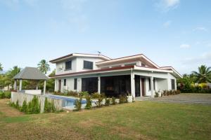 a house with a swimming pool in the yard at Sikeci Villa in Pacific Harbour