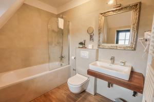 a bathroom with a sink toilet and a mirror at Green Garden Plitvice lakes in Plitvica Selo