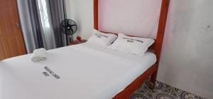 a bedroom with two beds with white sheets and pillows at Ngalula Half London Resort in Dzitsuhe