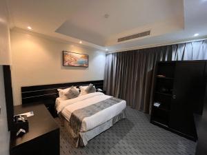 a hotel room with a bed and a desk at Art Suite in Riyadh +18 photos