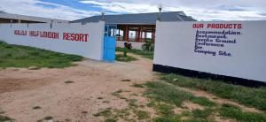 a sign in front of a building at Ngalula Half London Resort in Dzitsuhe