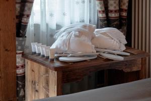 a wooden table with a bunch of candles on it at Francois Boutique Rooms - Matterhorn Retreat & SPA in Cervinia in Breuil-Cervinia