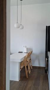 a dining room with a white table in a kitchen at Smovolo houses 1 in Agios Sostis