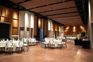 a large banquet hall with white tables and chairs at Amorita Resort Palawan in Puerto Princesa