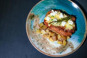 a plate of food with a piece of meat and potatoes at Amorita Resort Palawan in Puerto Princesa +17 photos