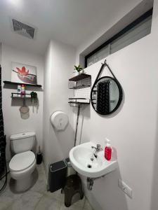 a bathroom with a white toilet and a sink at Unit 207C Amani Grand Resort & Residences in Pusok