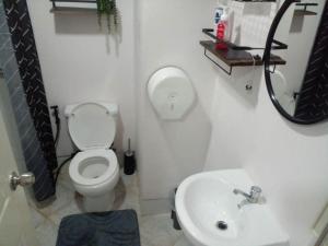a bathroom with a toilet and a sink at Unit 207C Amani Grand Resort & Residences in Pusok