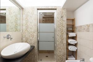 a bathroom with a sink and a mirror at Kore Luxury Suite e Spa in Naples