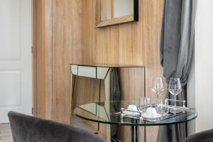 a glass table in front of a wooden wall at Kore Luxury Suite e Spa in Naples +56 photos