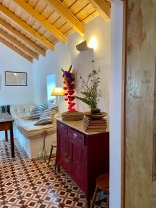 a living room with a red dresser and a couch at Bombom Comporta in Melides