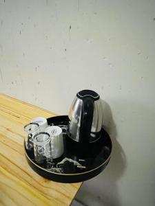 a tea kettle and cups on a tray on a table at Rest Easy Guest House Pty Ltd Unit 5 in Boksburg