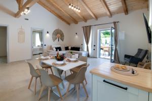 a kitchen and living room with a table and chairs at TS Luxury villa in Velianitátika