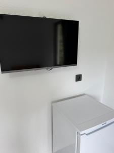 a flat screen tv hanging on a wall at Armeda Restoran ve Pansiyon in Datca