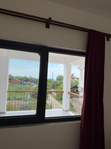 a window with a view of a balcony at Armeda Restoran ve Pansiyon in Datca