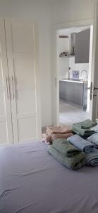 a bedroom with a bed with towels on it at Apartman Vida in Zaton