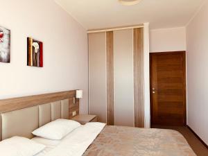 a bedroom with a bed and a wooden door at Tophill Altezza 9 Breathtaking Views and Terrace in Budva +34 photos