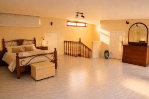 a bedroom with a bed and a dresser at Spacious Villa near Porto - BBQ and Private Parking in Vila Nova de Gaia