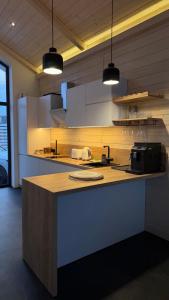 a kitchen with a counter top with two lights at be be Chalet mini - privat pool & jacuzi in Bukovel +8 photos
