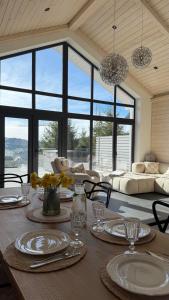 a dining room with a table with plates and glasses at be be Chalet mini - privat pool & jacuzi in Bukovel