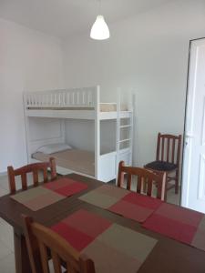 a dining room with a table and a bunk bed at Anna! in Ksamil