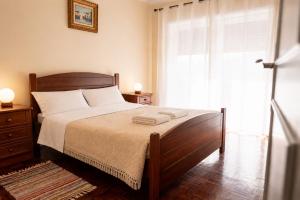 a bedroom with a bed and a large window at Spacious Villa near Porto - BBQ and Private Parking in Vila Nova de Gaia