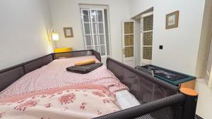 a bed in a small room with a bed frame at Patios de la Carmela in Isla Cristina