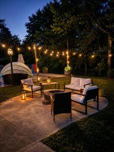 a patio with couches and tables and lights at night at Maxine Manor in Douglasville