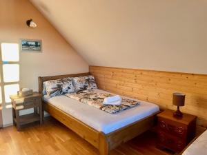 a small bedroom with a bed in a attic at Chalupa Beliankovo Ždiar in Ždiar