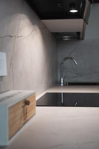 a kitchen with a sink and a counter top at J&B Imola Home in Imola +29 photos