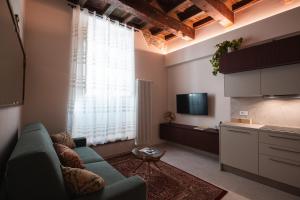 a living room with a blue couch and a kitchen at J&B Imola Home in Imola