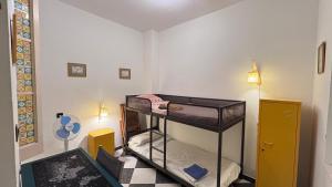a small room with two bunk beds in it at Patios de la Carmela in Isla Cristina