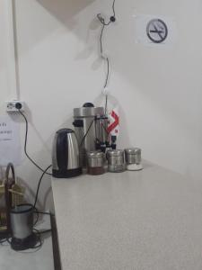 a kitchen counter with pots and pans on it at Oni Guesthouse in Oni